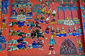 Wat Xieng Thong temple in Luang Prabang, Laos. the Ho Tai, the library. Colourful glass mosaics on a pink background with scenes of daily life. 